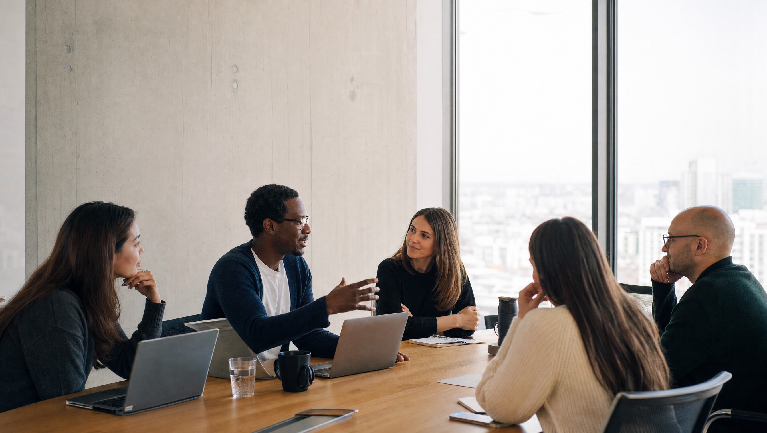 A team in a bright boardroom meeting